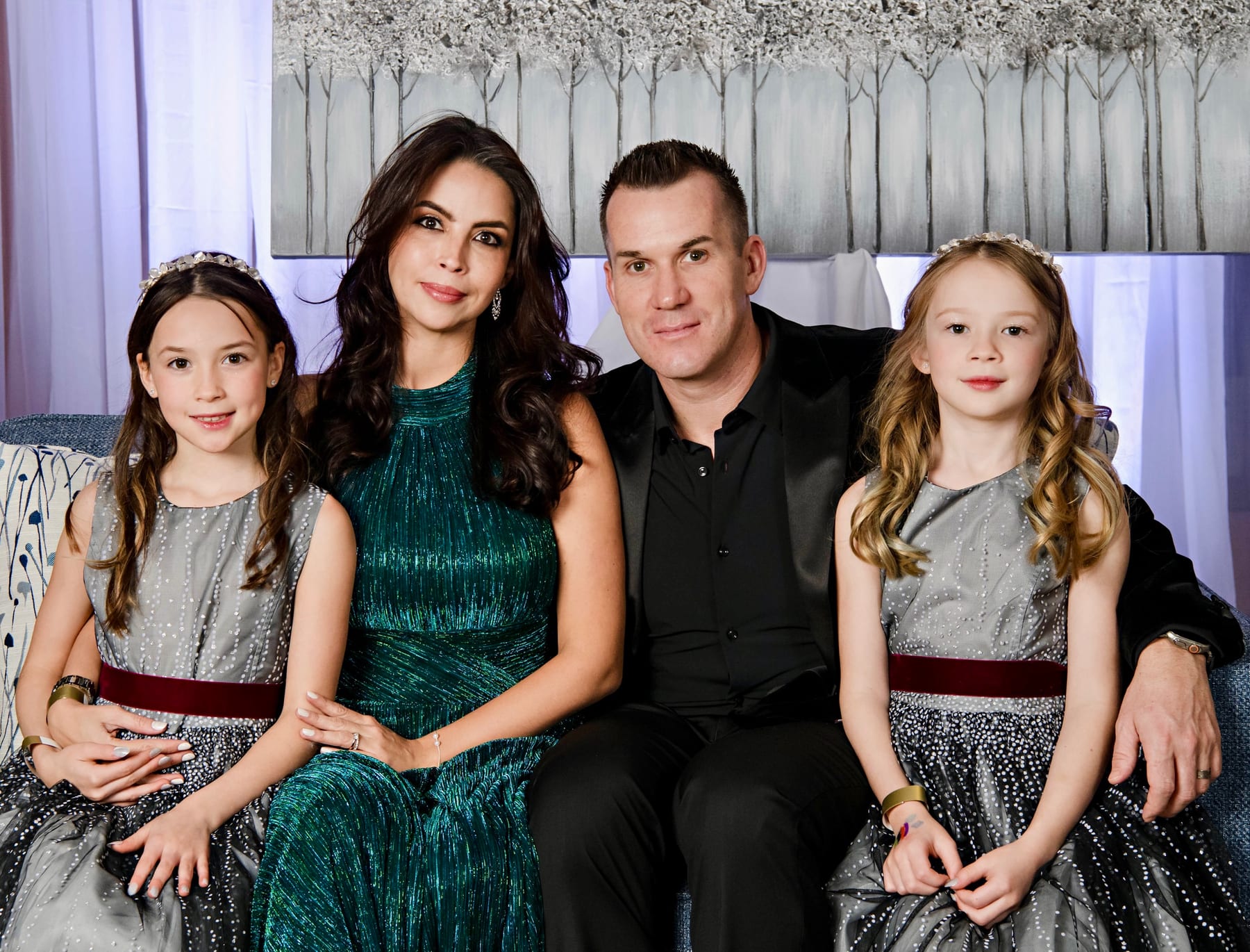 Jesse Hopps with his wife and two daughters, seated together